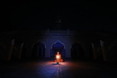 Man in illuminated building at night