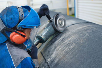 Rear view of man working in factory