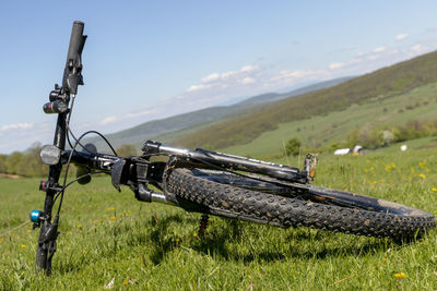 Bicycle on field against sky