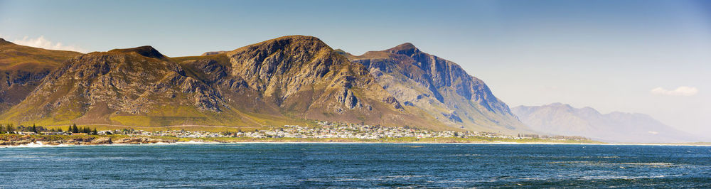 Panoramic view of sea and mountains against sky