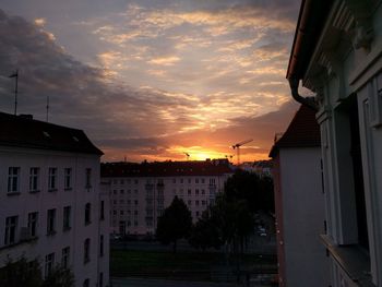 Residential buildings against sky during sunset