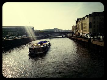 Boats in canal along buildings