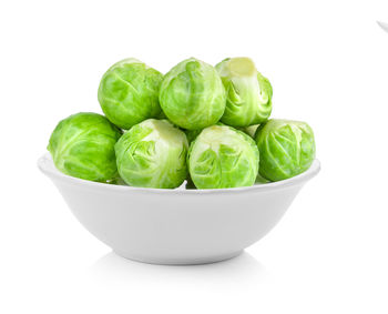 Close-up of vegetables in bowl against white background