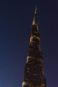 Low angle view of illuminated building against sky at night