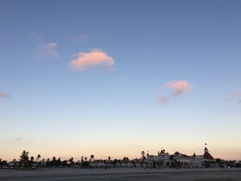 Panoramic view of river and buildings against sky at sunset