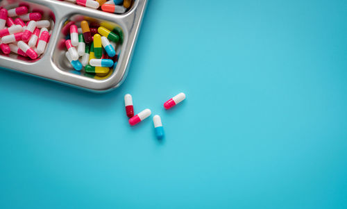 High angle view of pills on blue background