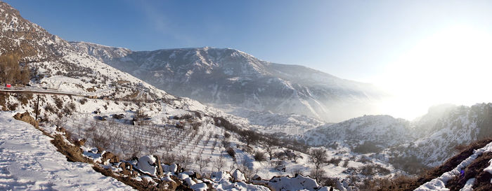 Panoramic view of snowcapped mountains against sky