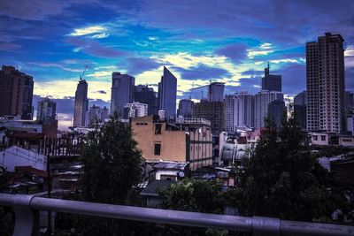 Skyscrapers against cloudy sky