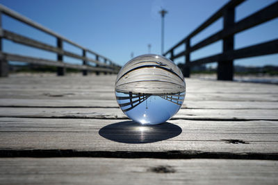 Close-up of light bulb on table against pier