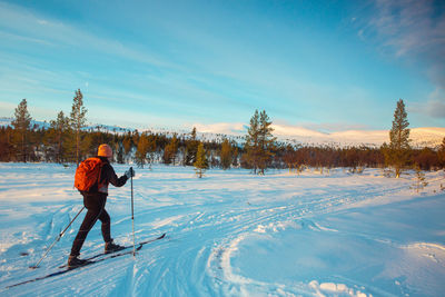 Man standing on snow against sky