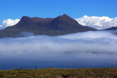 Scenic view of mountains against blue sky