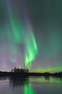 Scenic view of lake against sky at night