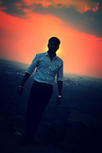 Silhouette man standing against sky during sunset