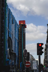 Road sign against sky in city