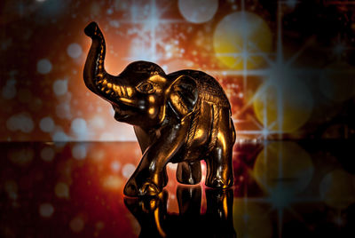 Close-up of elephant figurine on glass table