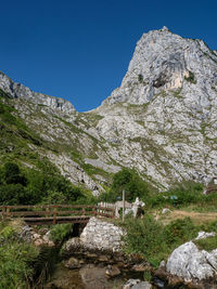 Scenic view of mountains against clear blue sky