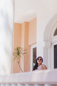 Portrait of woman against wall