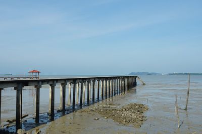 Pier over sea against sky