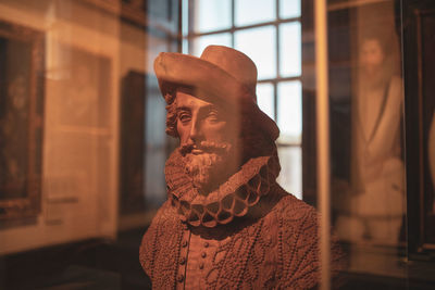 View of statue seen through glass