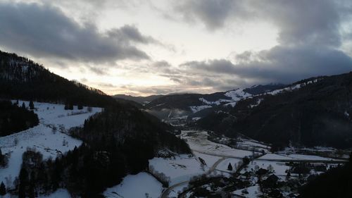 Scenic view of snow covered mountains against sky