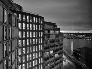 Buildings in city against cloudy sky