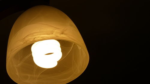 Directly below shot of illuminated pendant light in darkroom