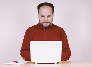 Mid adult man using laptop on table