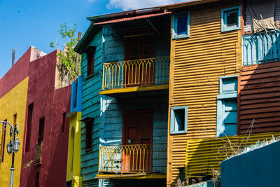 Low angle view of residential buildings against blue sky