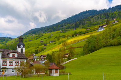 Houses on field against sky