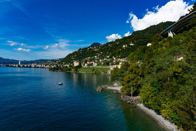 Scenic view of sea by buildings against sky