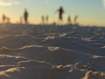 Close-up of sand against sky during sunset