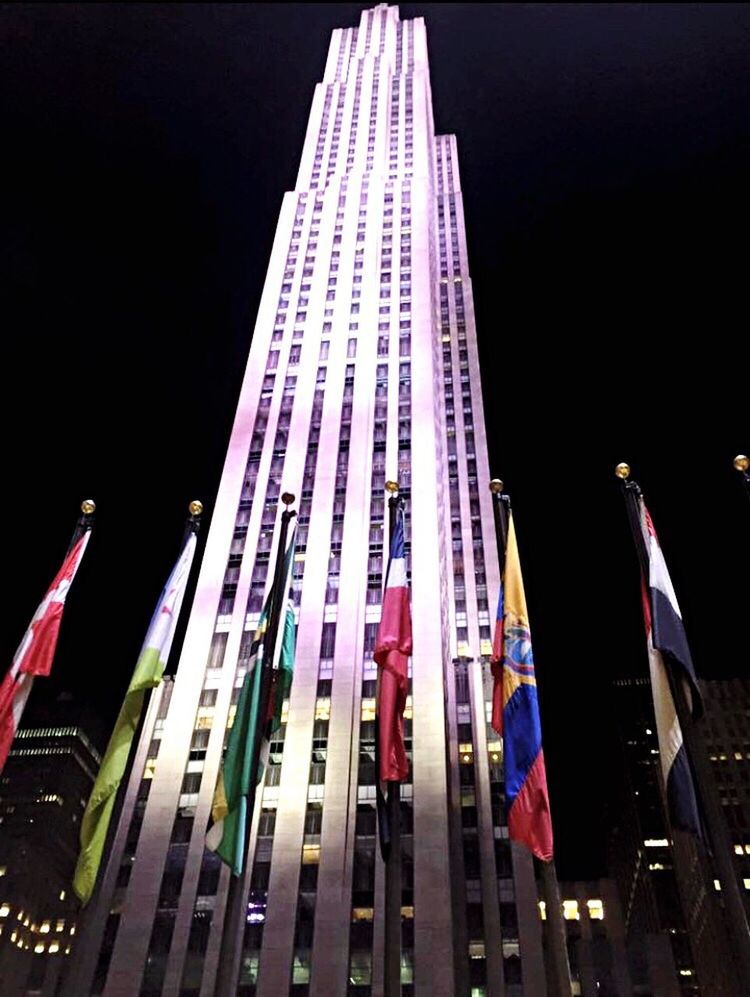 LOW ANGLE VIEW OF ILLUMINATED BUILDINGS IN CITY AT NIGHT