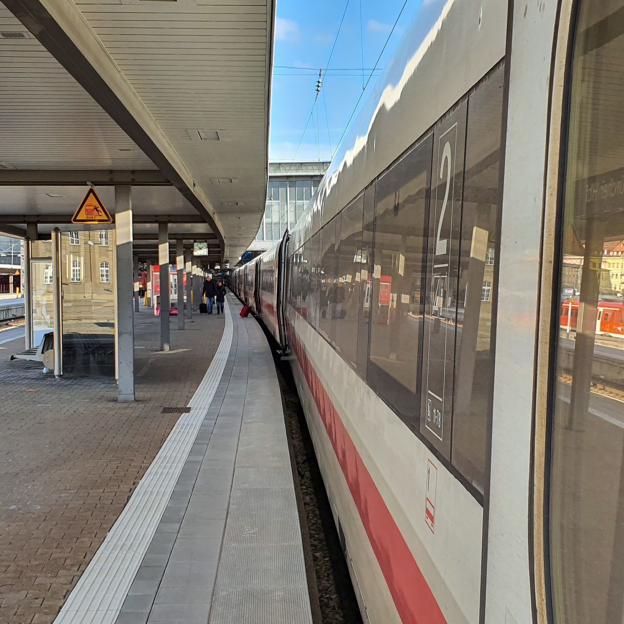 TRAIN AT RAILROAD STATION PLATFORM SEEN THROUGH WINDOW