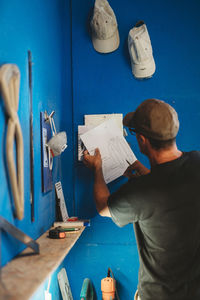 Man working on blue table