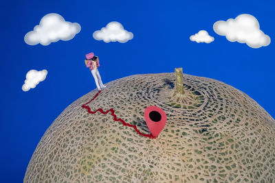 Low angle view of mannequin against blue sky