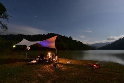 Scenic view of lake against sky at night