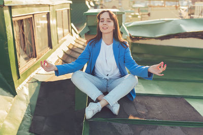 Portrait of young woman sitting on steps