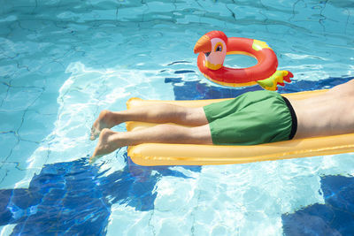 Full length of shirtless man in swimming pool