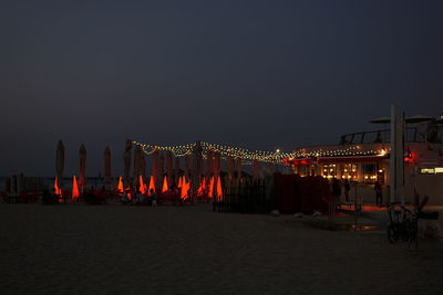 Panoramic view of illuminated sea against clear sky at night