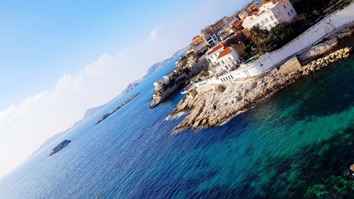 Aerial view of sea against blue sky