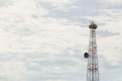 Low angle view of communications tower against sky