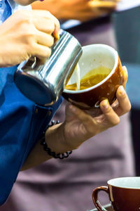 Close-up of hand holding coffee cup