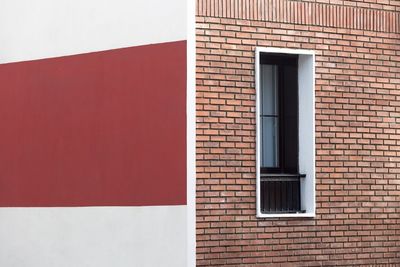 Red window on brick wall