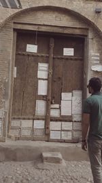 Full length of woman standing in front of building