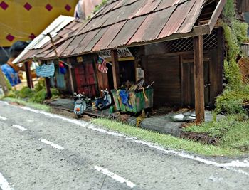 Houses by road against buildings in city