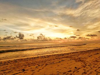 Scenic view of beach against sky during sunset