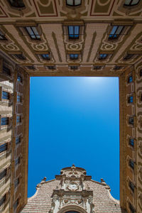 Low angle view of buildings against blue sky