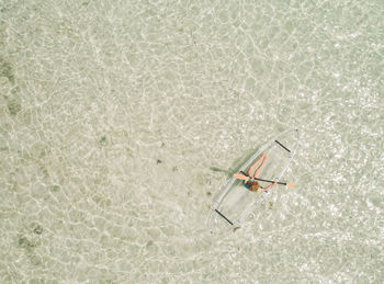 Aerial view of woman over inflatable boat in sea