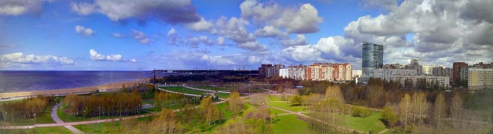 Built structure by river against cloudy sky