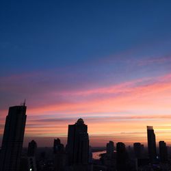 Silhouette of buildings against sky during sunset